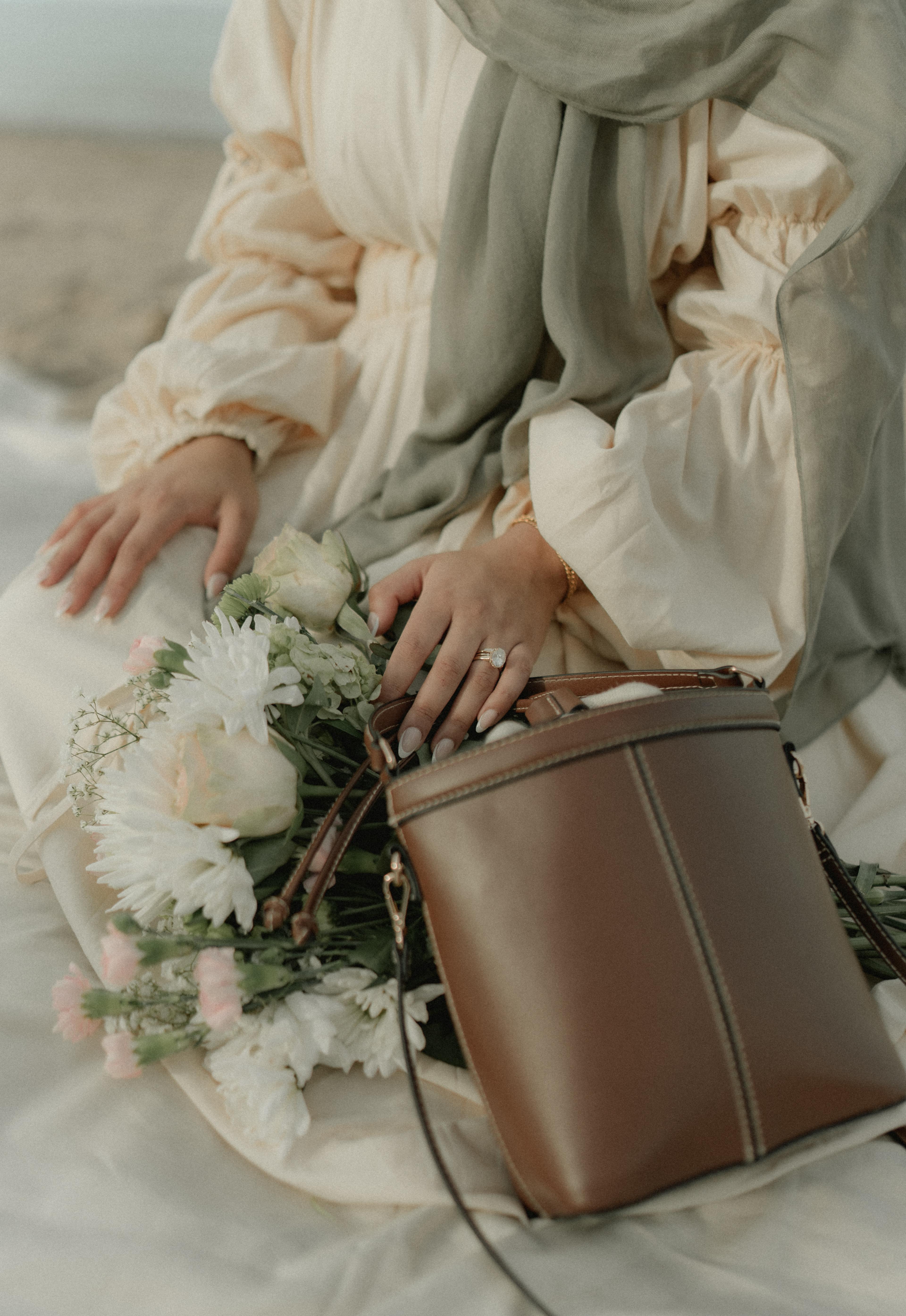 Beach picnic editorial — couple with engagement ring detail